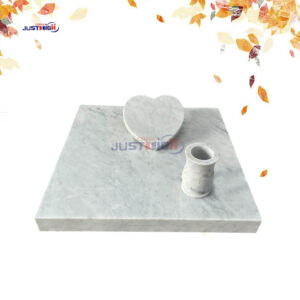 White marble heart shape tombstone.
